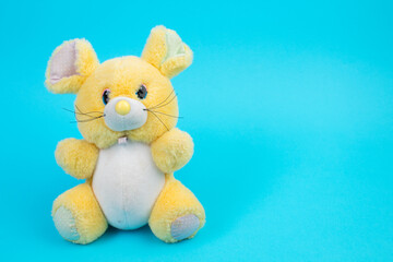 Pluche toy mouse on a blue background.