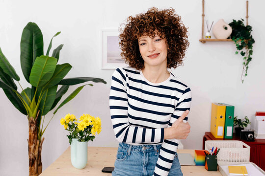 Cheerful woman Smiling and looking at camera in office