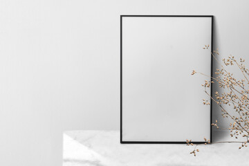 Picture frame mockup png leaning against the wall with house plant