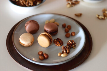 Cup of tea or coffee, cookies, macaroons, chocolate, various nuts and cocoa powder on white...