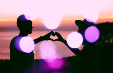 Sunset sky, bokeh and silhouette of couple with heart hand, emoji and light on romantic outdoor date. Love sign, man and woman with care, affection and relationship support on evening travel holiday.