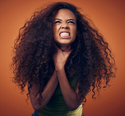 Woman, hair and angry with strangle in studio on brown background for damage, treatment and bad result. Female person, isolated and upset or disappointed at style with stress, unhappy and frustrated - obrazy, fototapety, plakaty