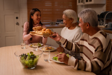 Family Togetherness in the Kitchen: Asian Mother Prepares a Happy Dinner, Joined by Father,...
