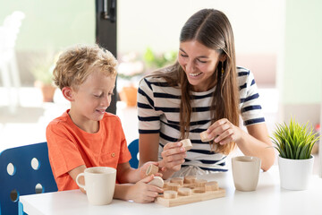 Engaging learning moment, Adult and child playing eith wooden educational toys
