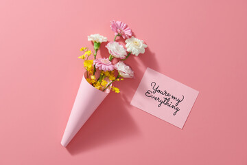 Beautiful flower bouquet and pink greeting card