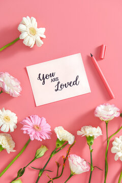 Postcard with composition of gerberas on pink background
