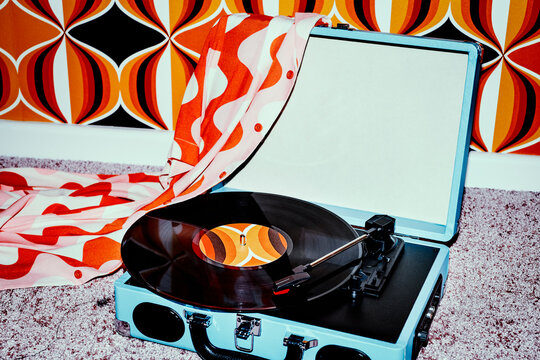 playing a record in a turntable on the floor