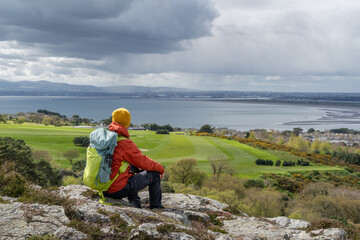 Hiker man admiring the landscape of Dublin Bay, Irish landscape.