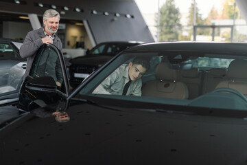 Modern car showroom exploring dashboard windsheld demonstration