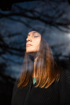 Portrait of a thoughtful woman through glass