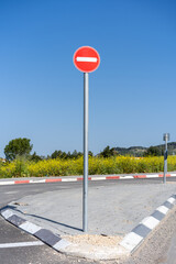 No-entry traffic sign stands prominently against the springtime landscape of Israel, symbolizing...