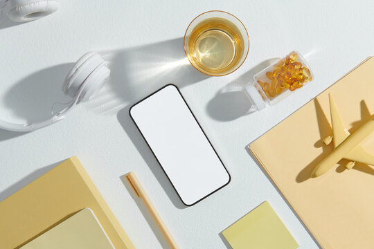 Top view of necessary travel accessories and blank screen mobile
