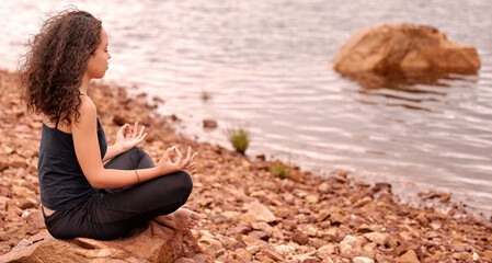 Water, peace and woman with lotus hands meditation at a lake for wellness, zen or mental health...