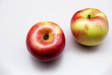 Apples with still-life concept. Close-up beautiful fruit texture of red apples. The concept of a healthy lifestyle, edible fruit, fresh and organic apple. Top view food with white background.