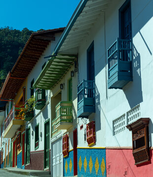 Street with multi colored facades in Jerico, Jeric&oacute;, Antioquia, Colombia. Wooden carved windows and balconies.