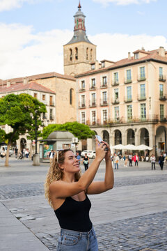 Travel Spain. Woman taking a phone picture
