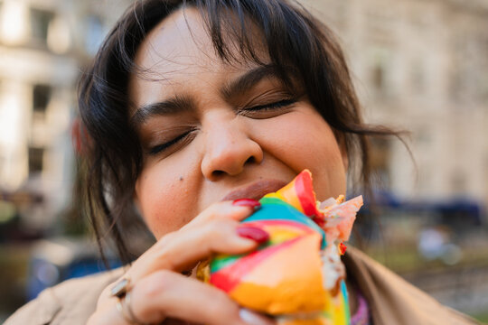 Candid moment of a latin woman eating her breakfast in the street.