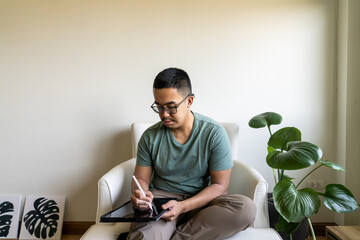 A Gen Z digital aritst illustrating on an iPad in their home office