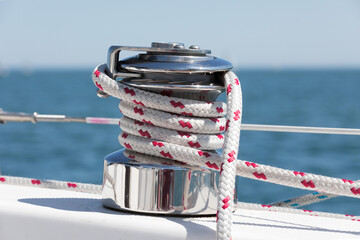 A sailboat main sheet winch with coiled red and white line
