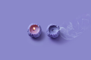 Blown out candle in form of human brain standing near burning one