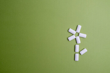 Tasty white chewing gums on color background, flat lay