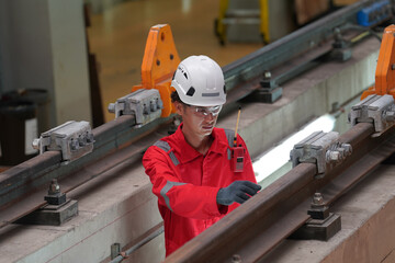 Professional technician worker hold light tube to check and maintenance part of train in electrical...
