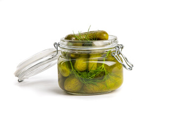 A glass home canning jar of baby dill pickles with the lid open isolated on white