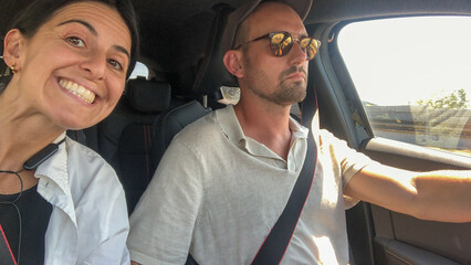 UGC POV selfie of couple driving a car