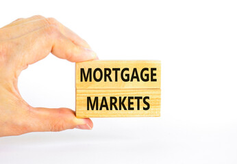 Mortgage markets symbol. Concept words Mortgage markets on beautiful wooden blocks. Beautiful white table white background. Businessman hand. Business mortgage markets concept. Copy space.