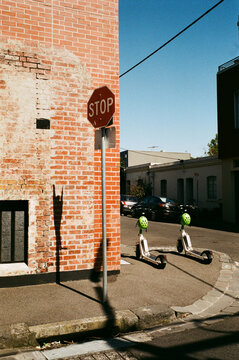 Two e-scooters on a street corner