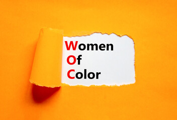 WOC women of color symbol. Concept words WOC women of color on beautiful white paper. Beautiful orange paper background. Business WOC women of color social issues concept. Copy space.