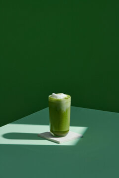 iced matcha latte green tea on green background