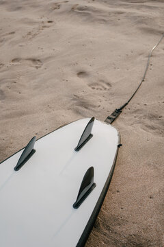 Closeup Shot of a Surfboard at a Beach During Sunset