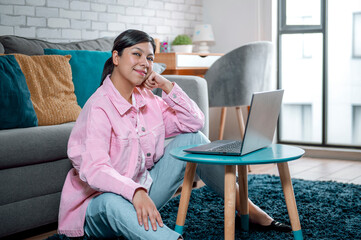 Pink Home Office: Capture the relaxed working and enjoyment of a young Mexican brunette, as she...