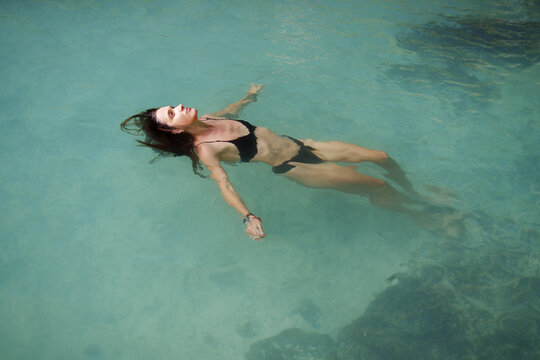 Serene Underwater Woman Floating in Clear Water