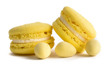 extreme macro closeup of yellow macaroon cookies and yellow mini Easter eggs on a white background