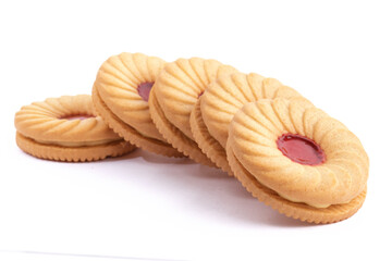 close up a curved line like dominoes of strawberry fruit creme cookies isolated on white

