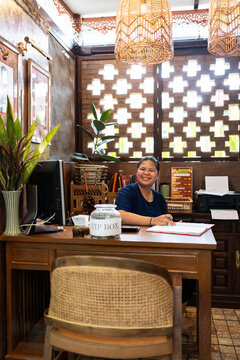 Woman working at the hostel desk.