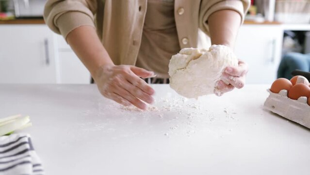 woman's hands knead the dough. Ingredients for cooking flour products or dough (bread, muffins, pie, pizza dough). 