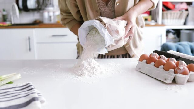 woman's hands knead the dough. Ingredients for cooking flour products or dough (bread, muffins, pie, pizza dough). 