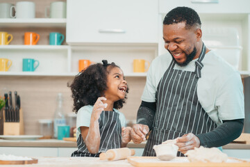 In a home kitchen, black father and his daughter bond over cooking a meal food, their laughter and love filling the air, embodying the joy of African American family life, Father's Day concept