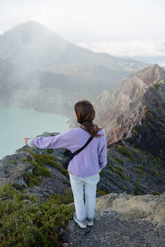 Female Travel Looking Over Mountains and Misty Landscape at Dawn
