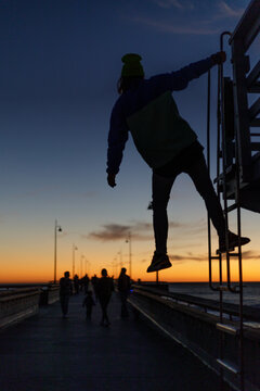 Guy on the pier at sunset