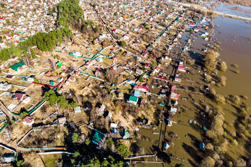 Dacha plots with houses flooded during heavy floods in spring, view from a drone