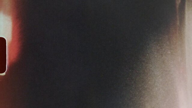 Scratched Damaged Footage Transition. Animation of a blank loopable old vintage damaged 8mm film tape