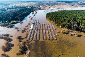 Farmland flooded with water during a strong river flood in spring, view from a high altitude