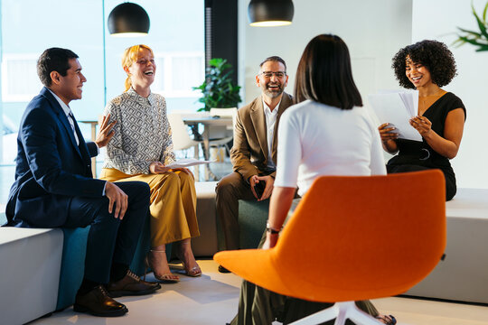 Cheerful lawyers discussing project in office