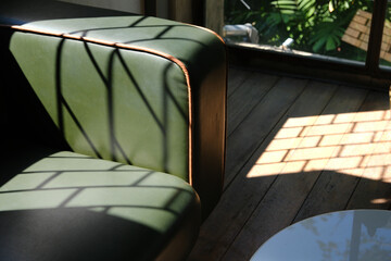 Shadow of sunlight on the green sofa