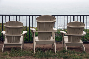 Adirondack chairs on a foggy day on the California coas