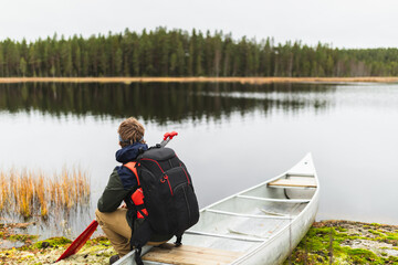 Relaxed man sitting in kayak in wilderness adventure